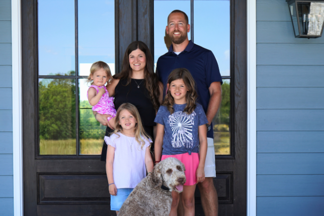 A family in front of their home.